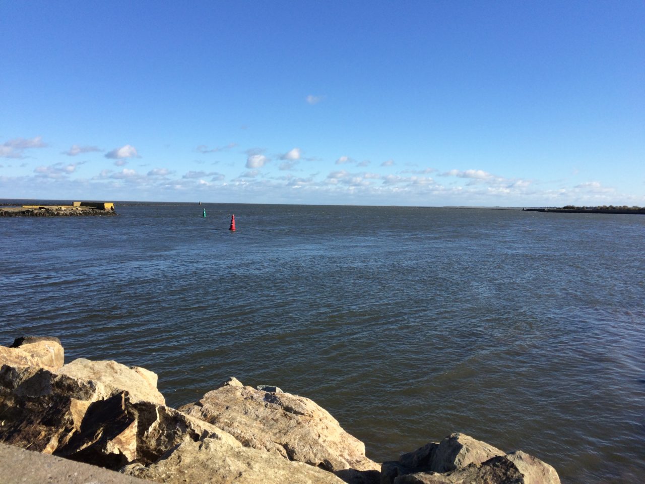 sea shore rocks sky blue scene clouds